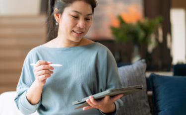 woman looking at tablet with pen in hand image