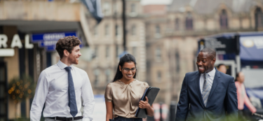 woman and two men walking in street large hero image