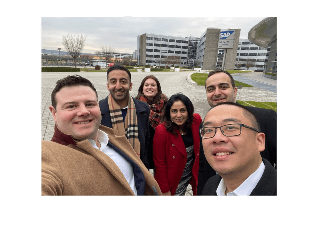 Selfie image of Taulian employees outside of building